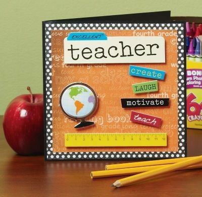 a teacher's desk with an apple and pencils