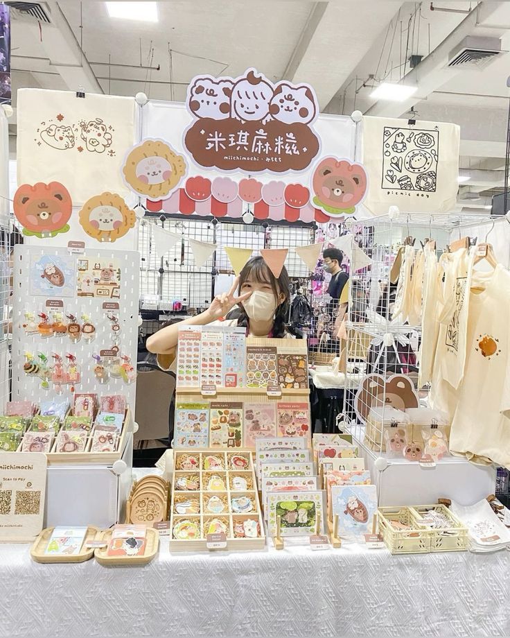 a woman standing in front of a table with many items on it