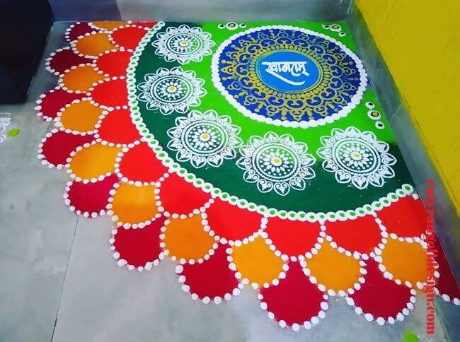 a colorful rangdi design on the ground in front of a yellow wall