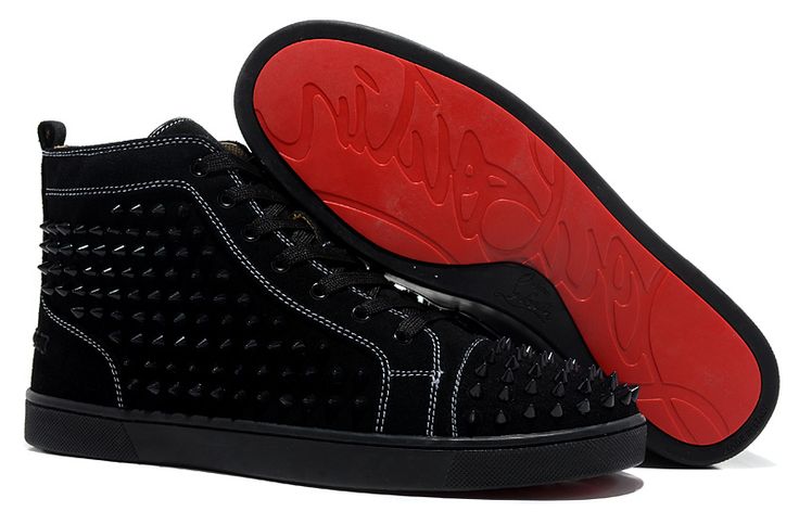 a pair of black shoes with red soles on top of each shoe is shown