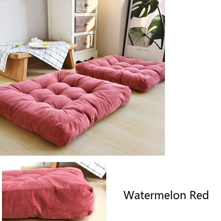 the futon bed is made from red velvet and has a large square cushion on it