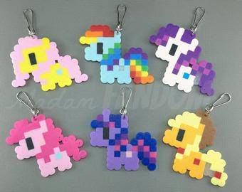 the pixel keychains have been made out of different types of plastic beads and are colorful