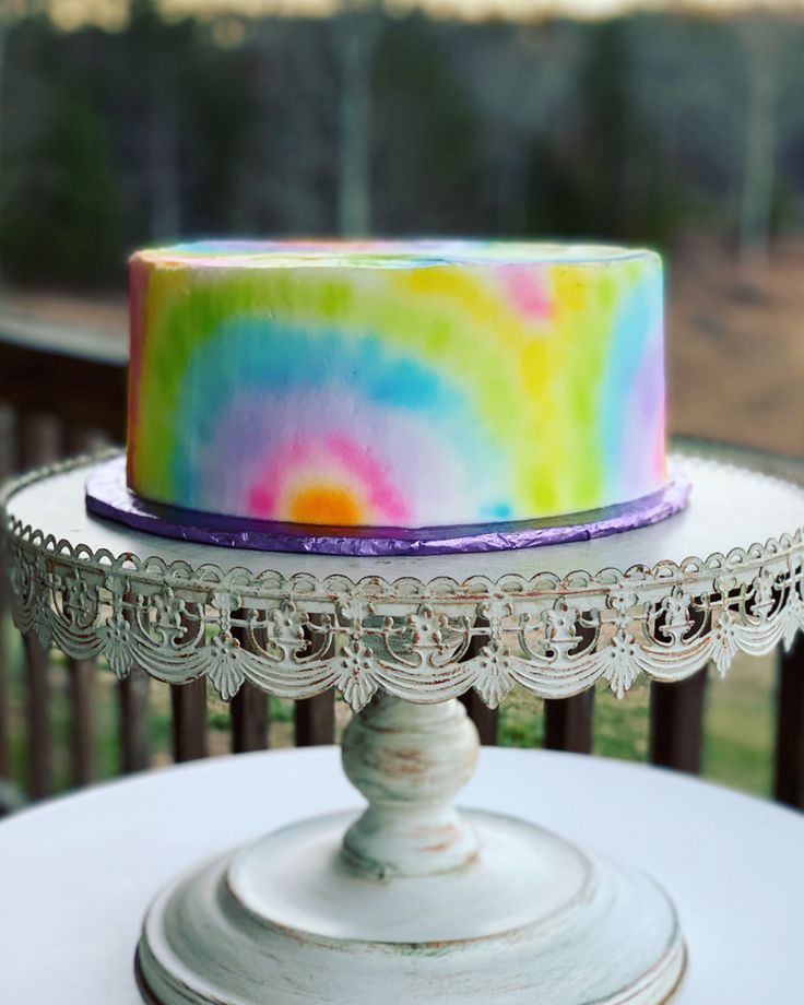 a multicolored cake sitting on top of a table