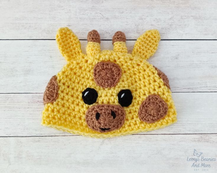 a crocheted giraffe hat with black eyes