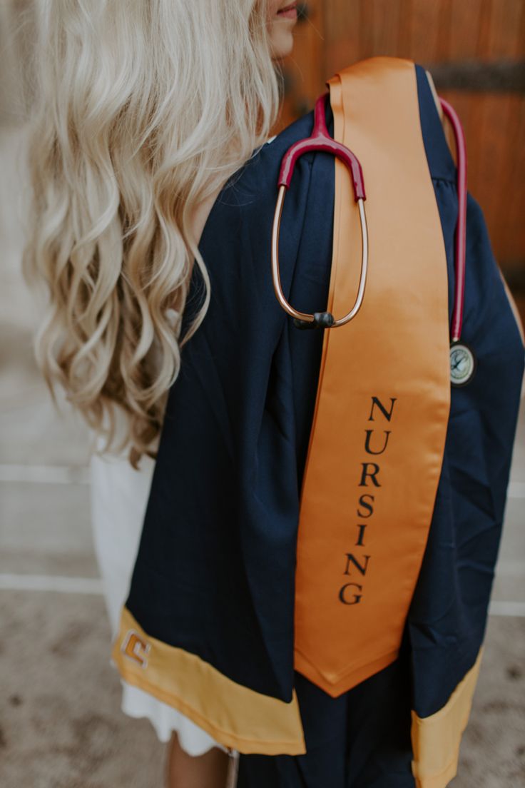 a blonde haired woman with a stethoscope on her back wearing a blue and orange nursing backpack