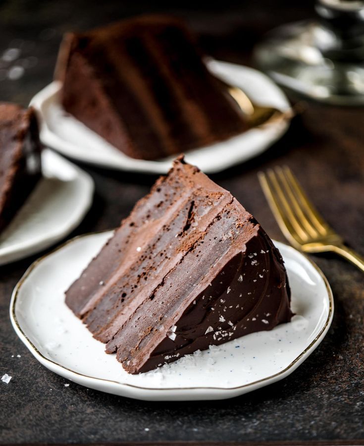 two plates with slices of chocolate cake on them