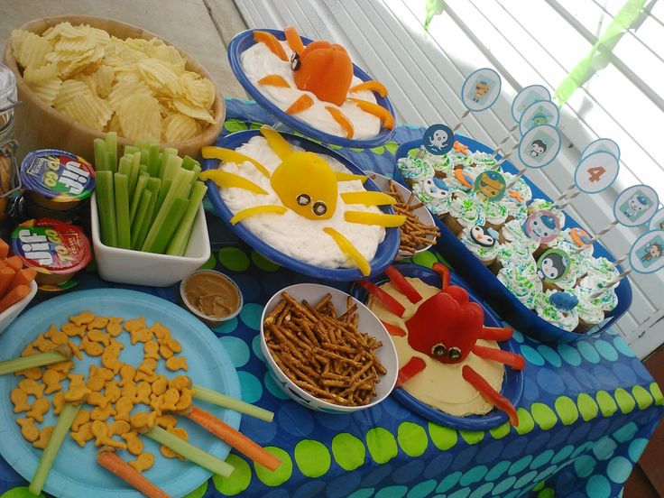 a table topped with lots of food and snacks