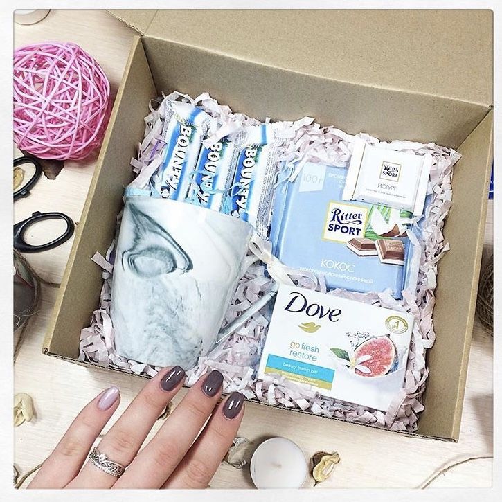 a woman's hand is shown with her manicures and other items in a box