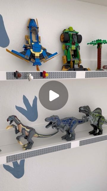 legos are lined up on the wall in front of each other, and one has a toy dinosaur