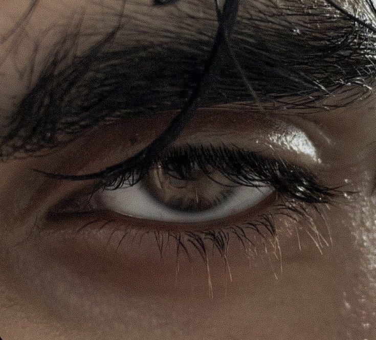 the eye of a man with long black hair