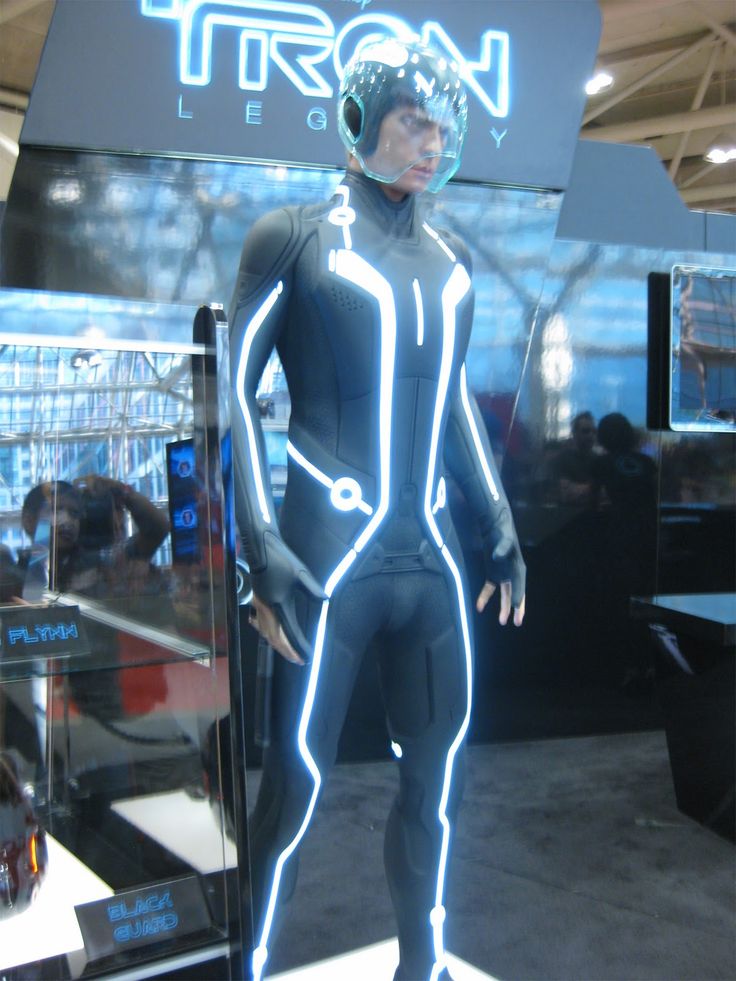 a mannequin is standing in front of a neon sign that says tron leggy