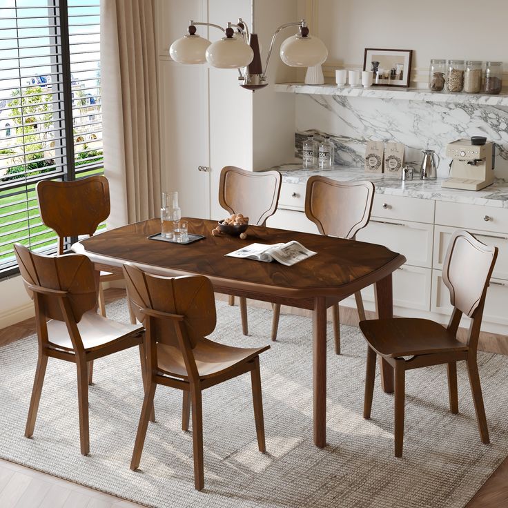 a dining room table with four chairs and a white rug in front of the window