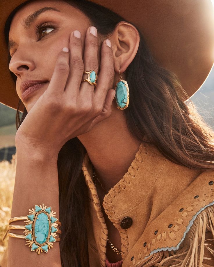 Let your accessorizing do the talking when you style the Havana Vintage Gold Cuff Bracelet in Variegated Turquoise Magnesite. The boldest bracelet in the West, this cuff features hammered metal, textured adornments, and a statement-sized stone center. This bracelet is a part of Yellow Rose by Kendra Scott—a brand that celebrates ranch life with Kendra Scott staples alongside select curated jewelry pieces and accessories. Metal Vintage 23k Yellow Gold Over Brass Material Variegated Turquoise Magn Jewelry Brand Photography, Gold Western Jewelry, Turquoise And Gold Jewelry, Gold Turquoise Jewelry, Vahan Bracelets, Gold And Turquoise Jewelry, Western Turquoise Jewelry, Pink Quartzite, Turquoise Jewelry Gold