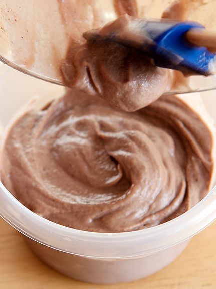 a person is mixing chocolate in a container