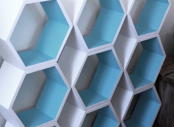 several white and blue hexagonal shelves stacked on top of each other in the same pattern