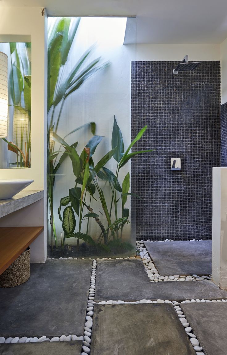 a bathroom with stone flooring and tiled walls