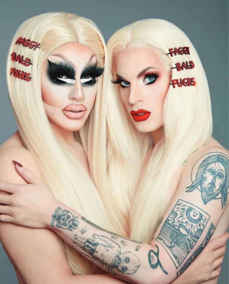 two women with makeup on their faces are hugging each other while wearing fake wigs