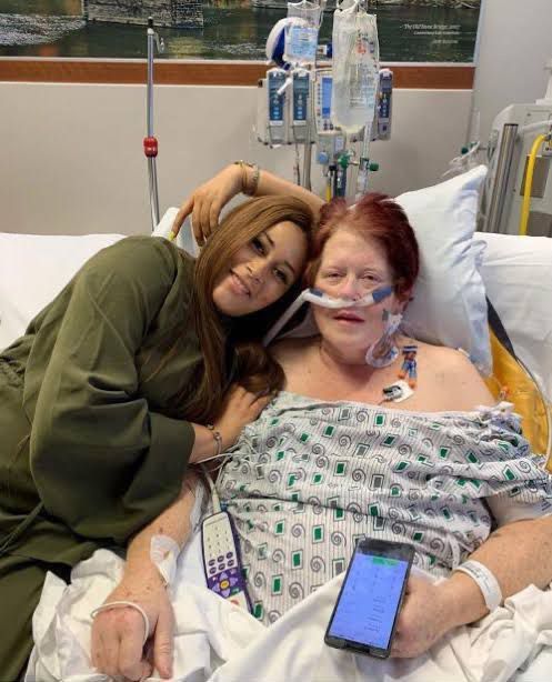 two women laying in a hospital bed next to each other