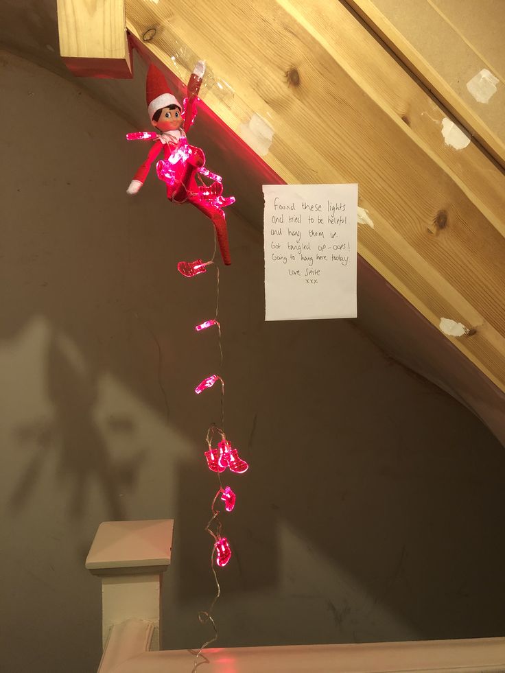 a pink light up doll hanging from the ceiling