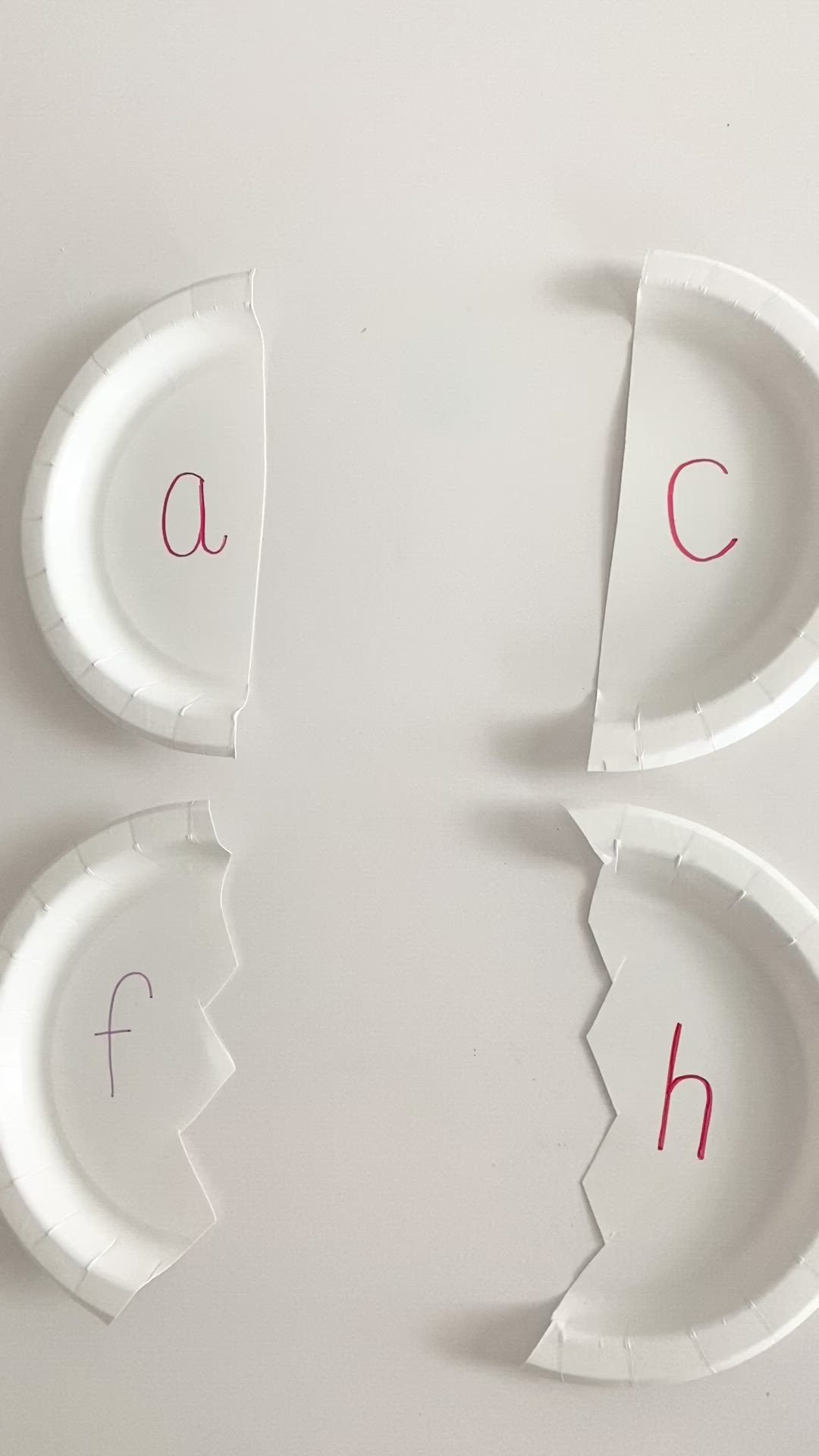 This may contain: four paper plates that have different types of objects on them, including letters and numbers