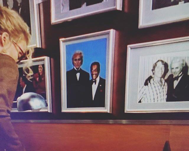 In the background of BATMAN RETURNS Max Shreck (Christopher Walken) has a wall of photos with him &amp; celebrities like Sammy Davis jr and Arnold Schwarzenegger.: MovieDetails