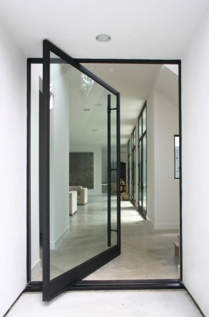 Framed glass pivot front door.