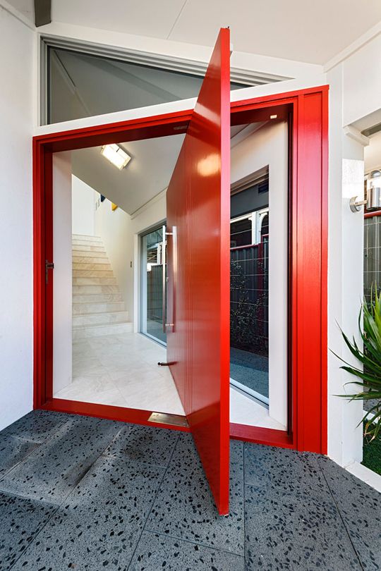 Bold red oversized pivot door.