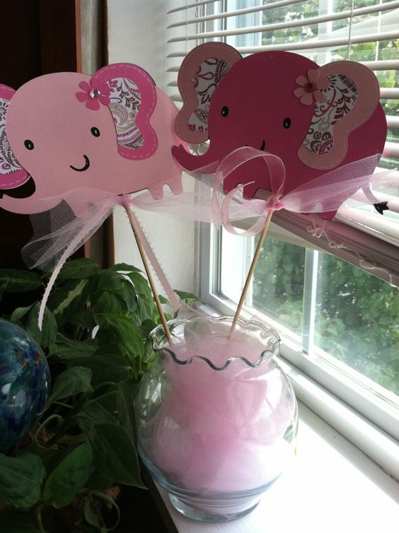 Pink elephant props in a vase are a very easy idea.