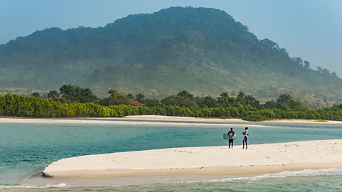 Two people on a beach in Sierra Leone (Credit: Alamy)