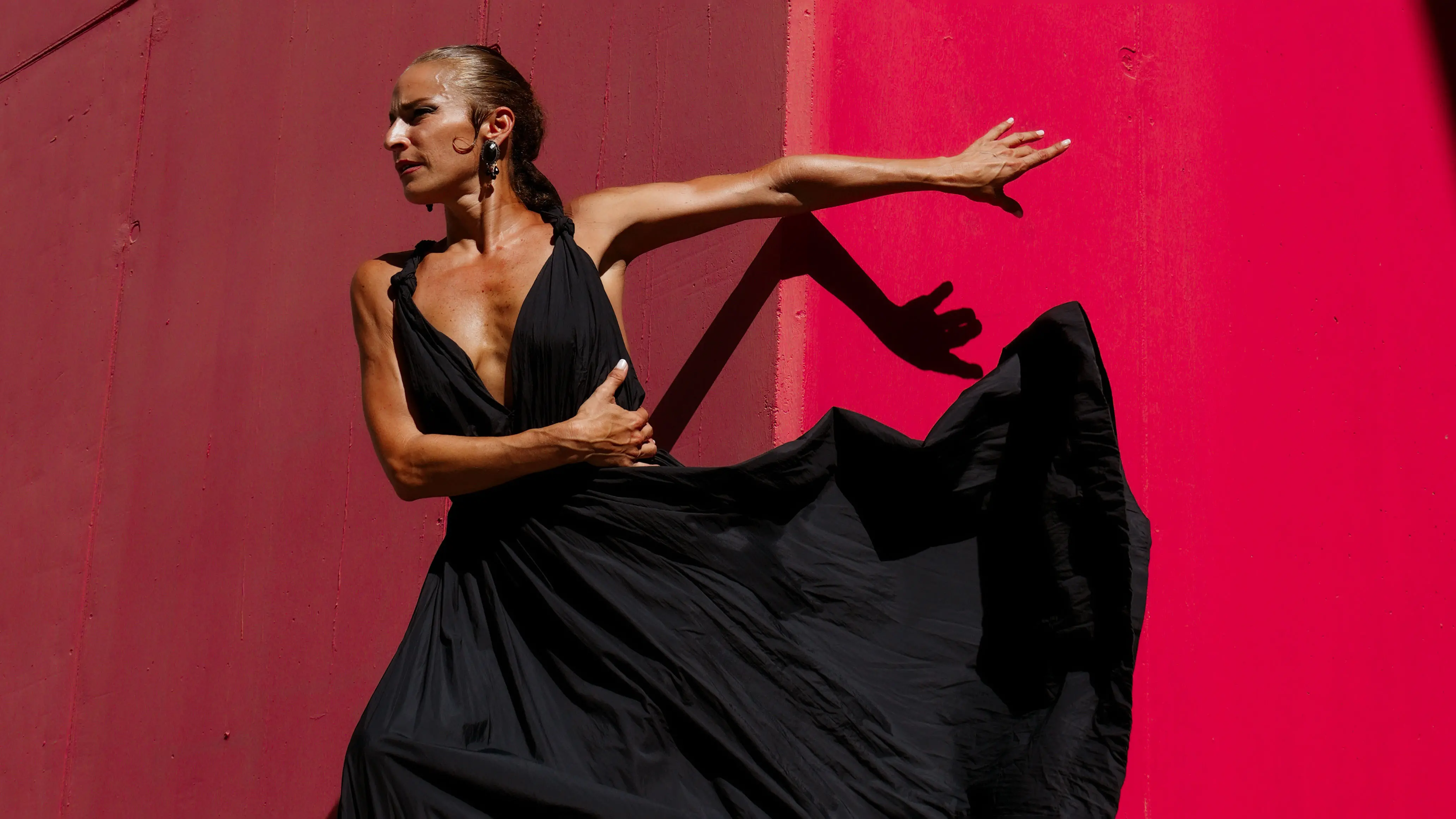 A flamenco dancer on stage surrounded by musicians