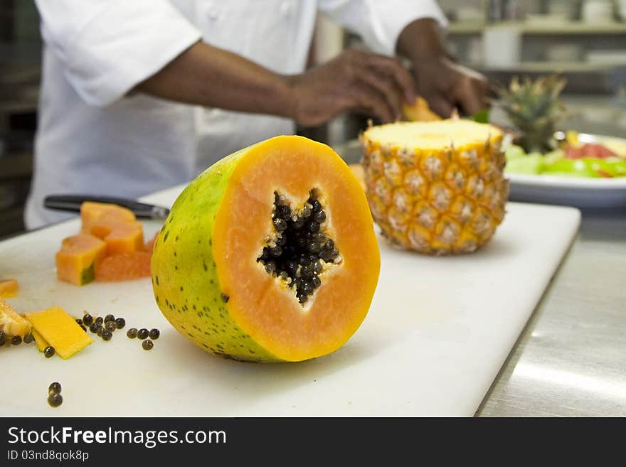 African chef preparing an exotic fruit platter. African chef preparing an exotic fruit platter