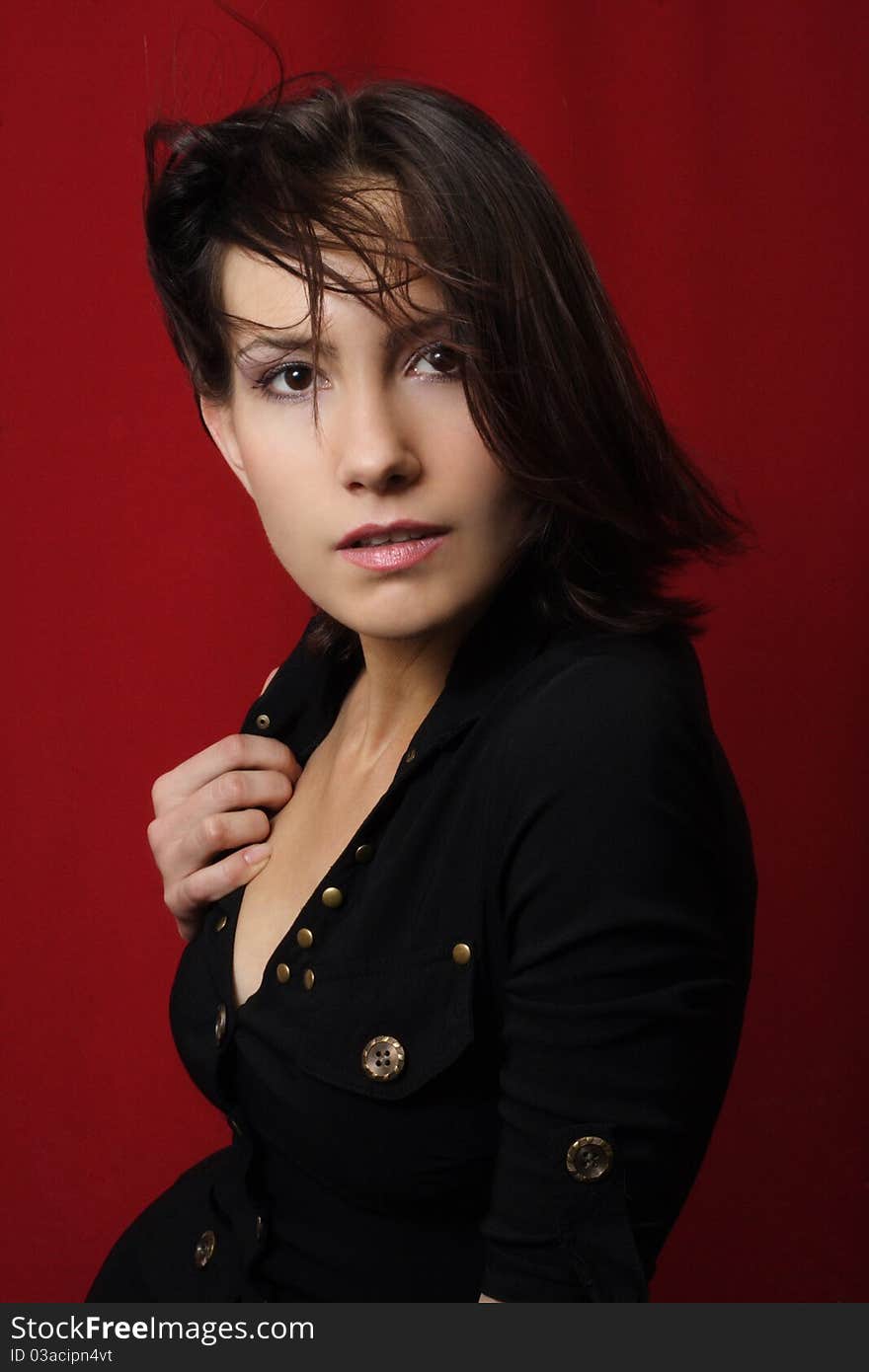 Portrait of the brunette on a red background. Portrait of the brunette on a red background