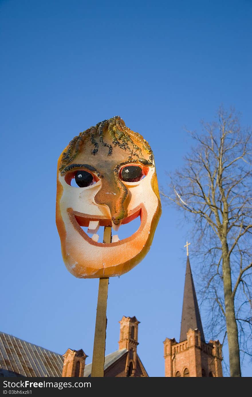 Mardi Gras mask on sky background