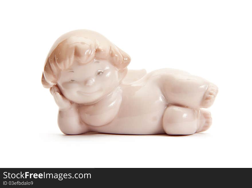 Figurine of angel lying on white background