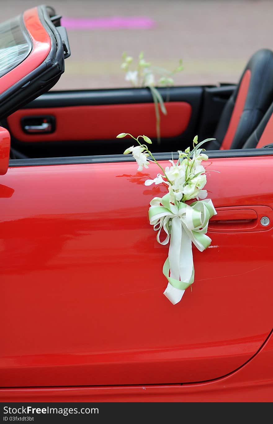 Flowers on a red wedding car. Flowers on a red wedding car