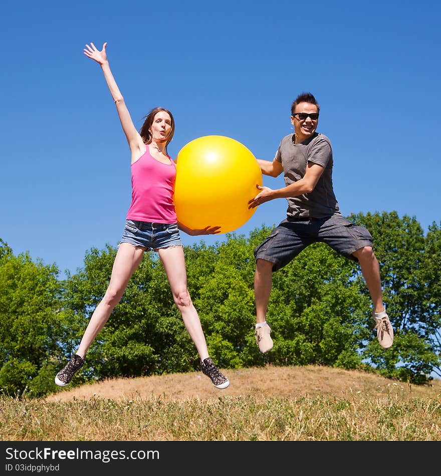 Young people play with yellow ball