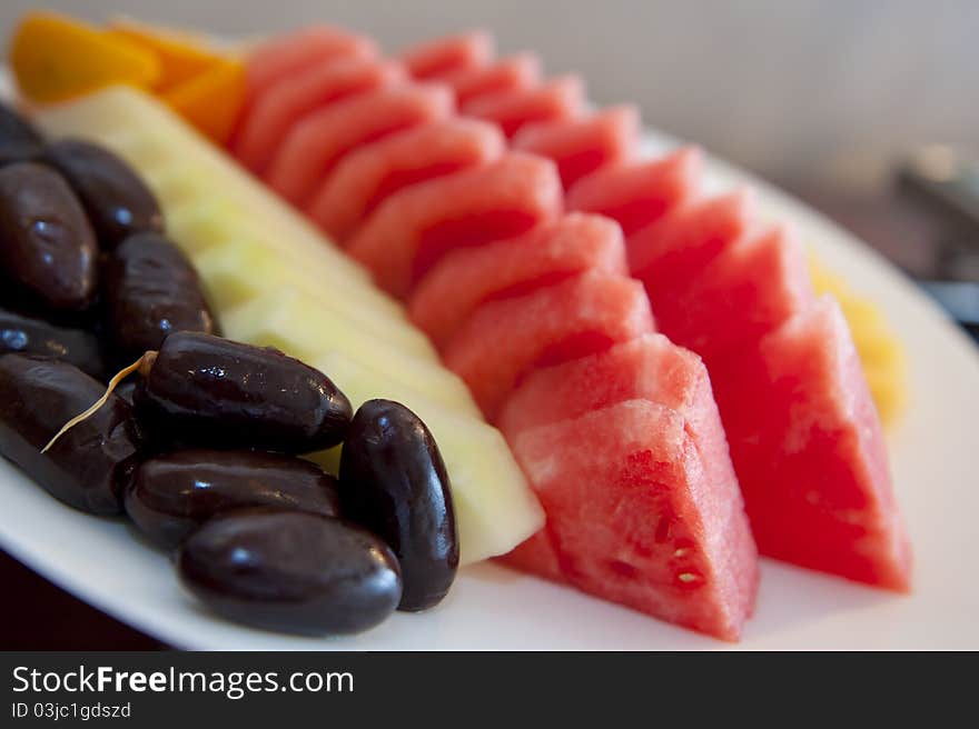 Nicely cut and arranged fruits on a platter tray ready to be served. Nicely cut and arranged fruits on a platter tray ready to be served.