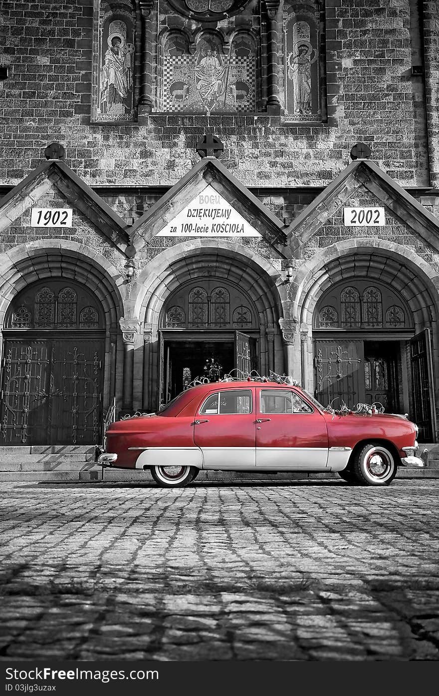 Antique red car parked in front of your young stone church during the wedding ceremony. Antique red car parked in front of your young stone church during the wedding ceremony.