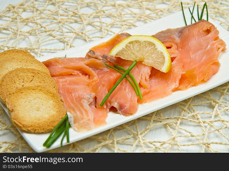 Smoked salmon on white dish