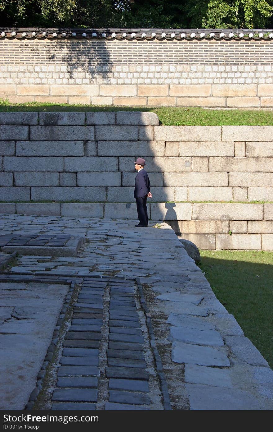 Korean man standing alone in temple grounds