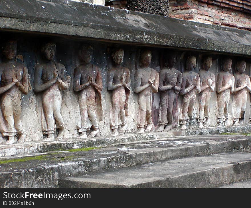 Thai Temple with a row of praying figurines