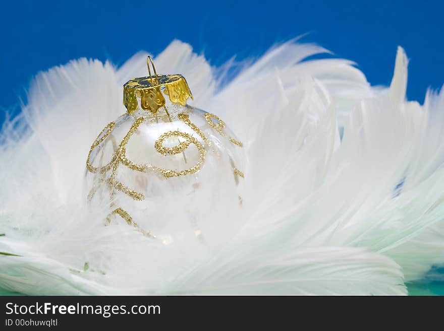 Christmas ball on white feather