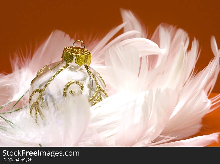 Christmas ball on white feather