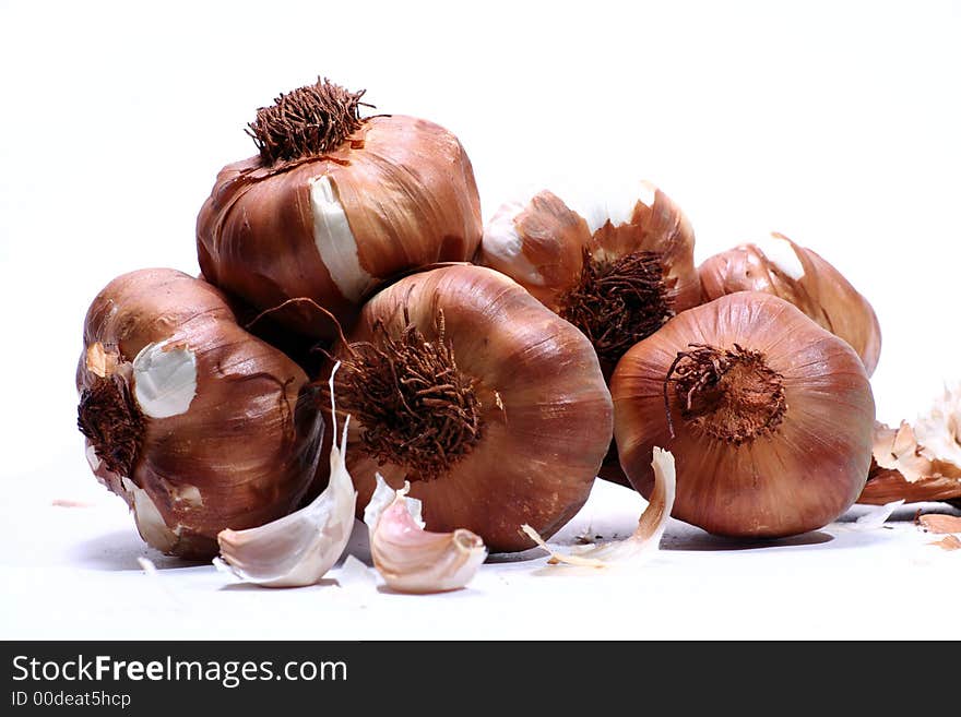 A bundle of smoked garlic isolated on a white background.