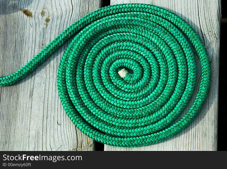 Tightly wound patterned textured green rope. Tightly wound patterned textured green rope