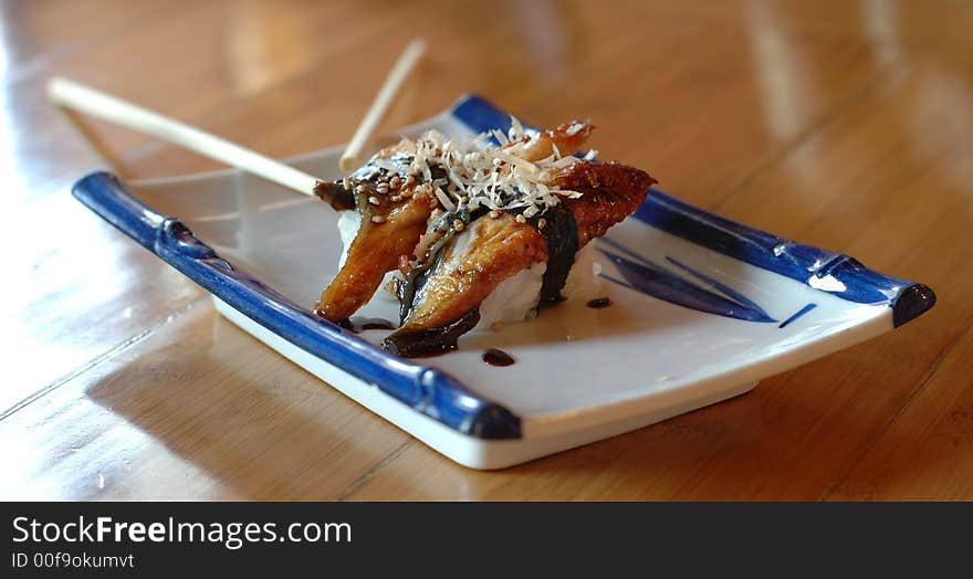 Smoked eel unagi rolls on a Japanese platter. Smoked eel unagi rolls on a Japanese platter