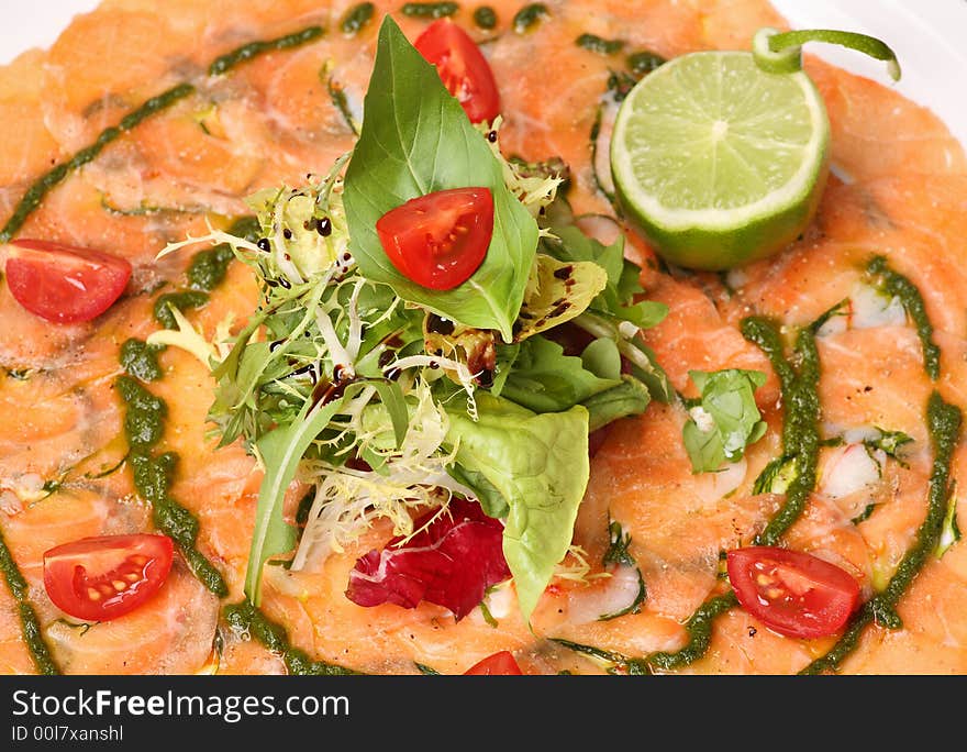 Italian dish: carpaccio with salmon and lemon (lime) and fresh pesto