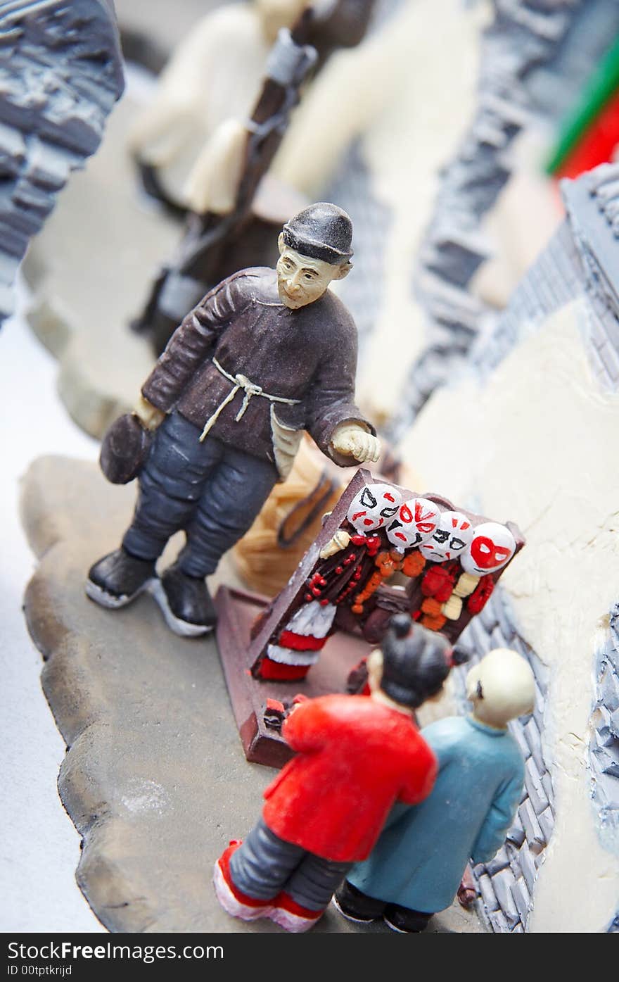 Chinese  cartoon figurine, businessman saling toys to child in ancient  Beijing street.  porcelain,traditional,handmade. Chinese  cartoon figurine, businessman saling toys to child in ancient  Beijing street.  porcelain,traditional,handmade.