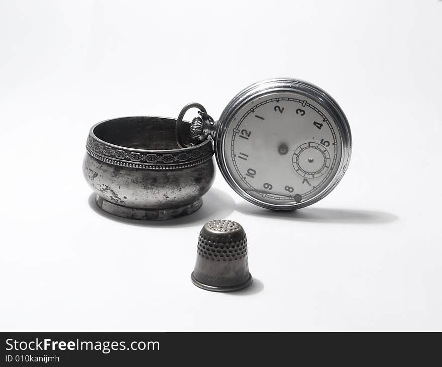 Pocket watch; household goods; white background; salt-cellarsilver; thimble; clock. Pocket watch; household goods; white background; salt-cellarsilver; thimble; clock