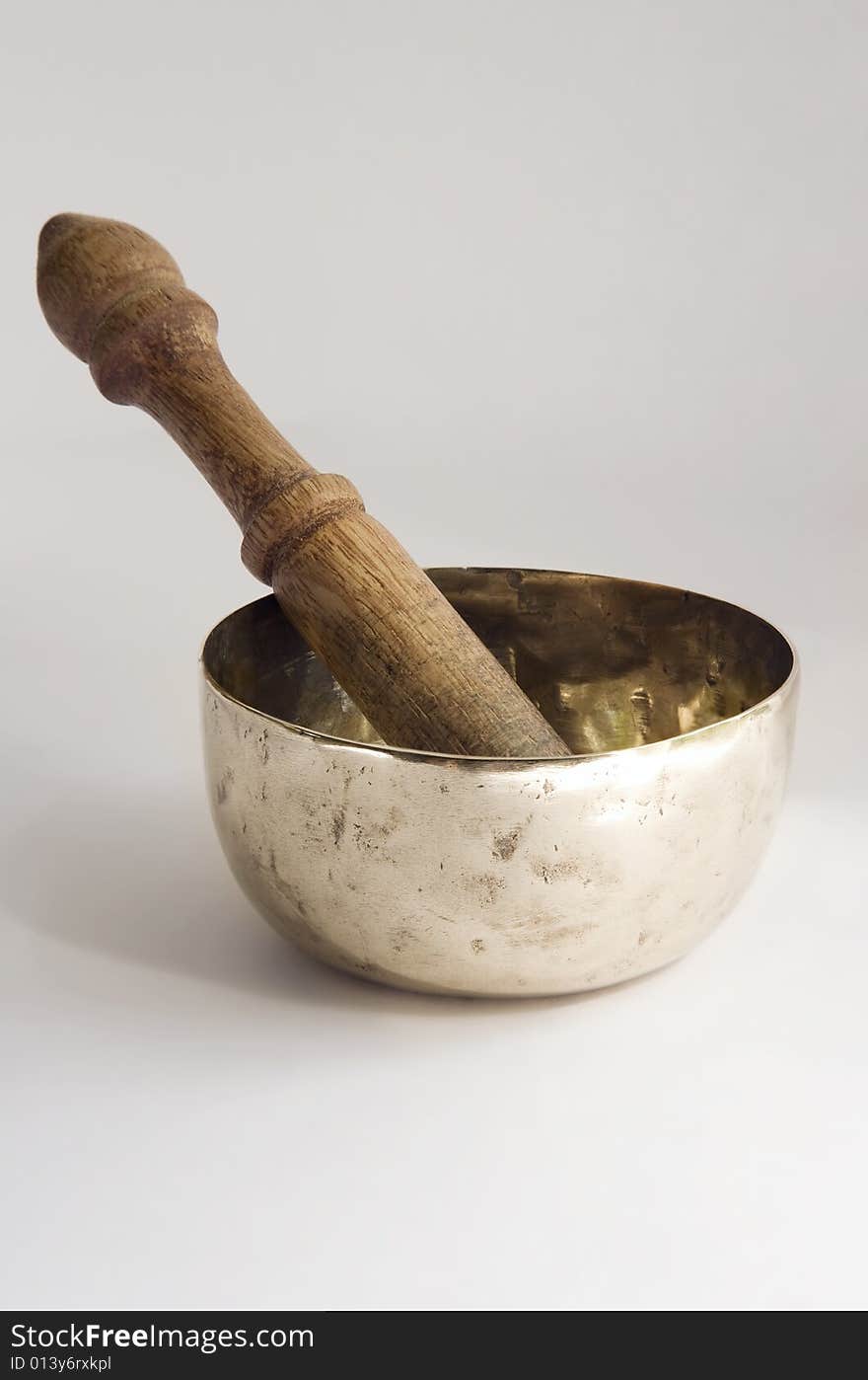 Bronze singing bowl or standing bell, with wooden mallet, used in Buddhist spiritual traditions, for meditation, relaxation, healthcare, personal well-being and religious practice. Bronze singing bowl or standing bell, with wooden mallet, used in Buddhist spiritual traditions, for meditation, relaxation, healthcare, personal well-being and religious practice.